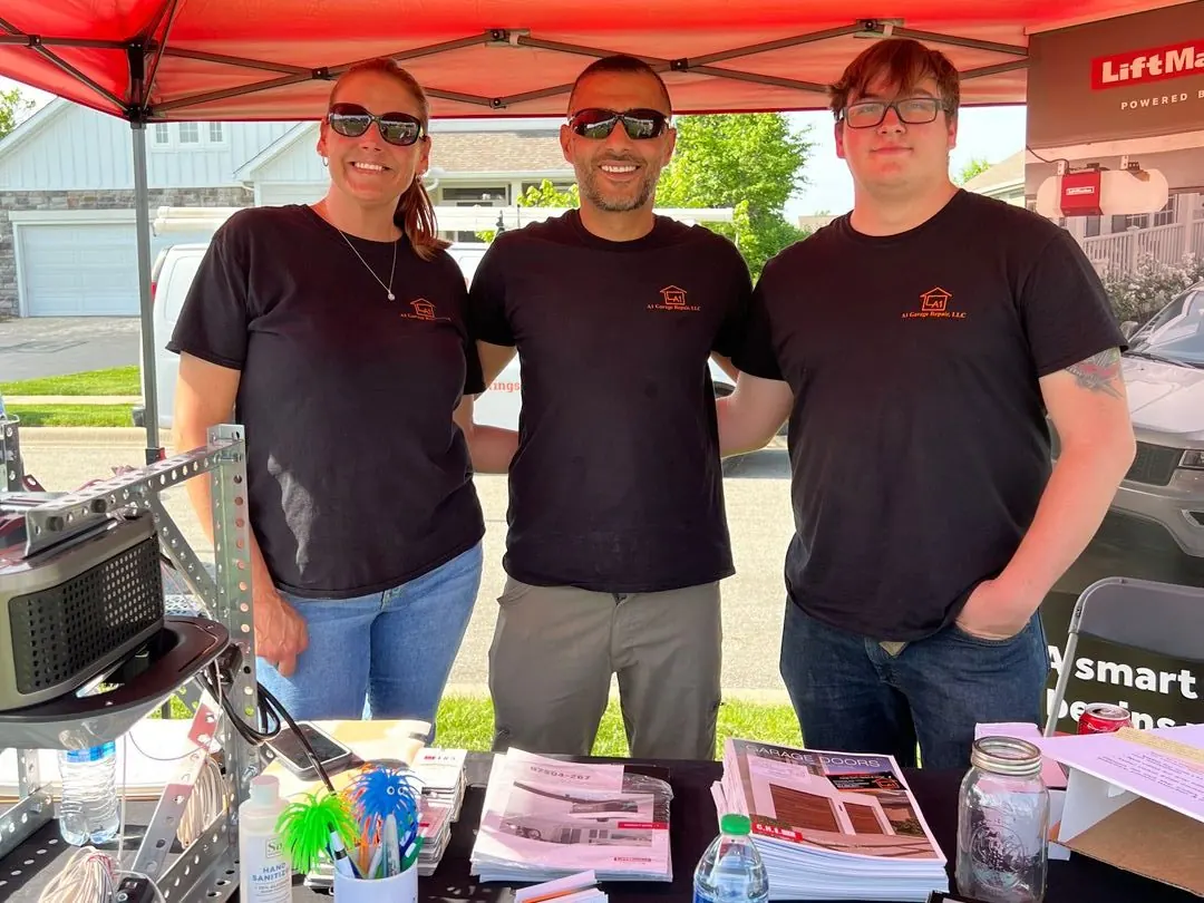 Three A1 Garage Repair team members at the company booth at a community event