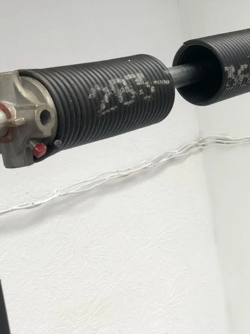 A torsion spring, the part that lifts the door