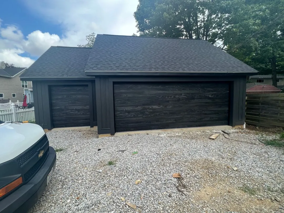 Dark wood-look doors on a detached garage