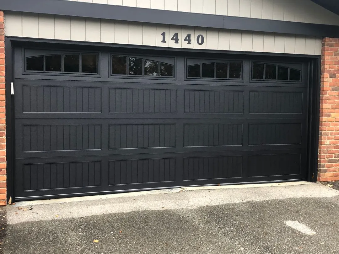 Black carriage-style door with arched top windows