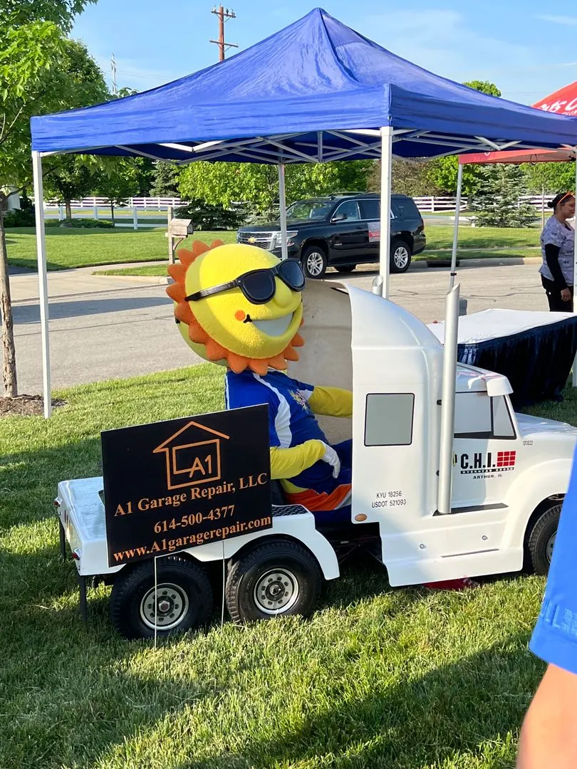 A1 Garage Repair display with a small truck and the company sign at a community event